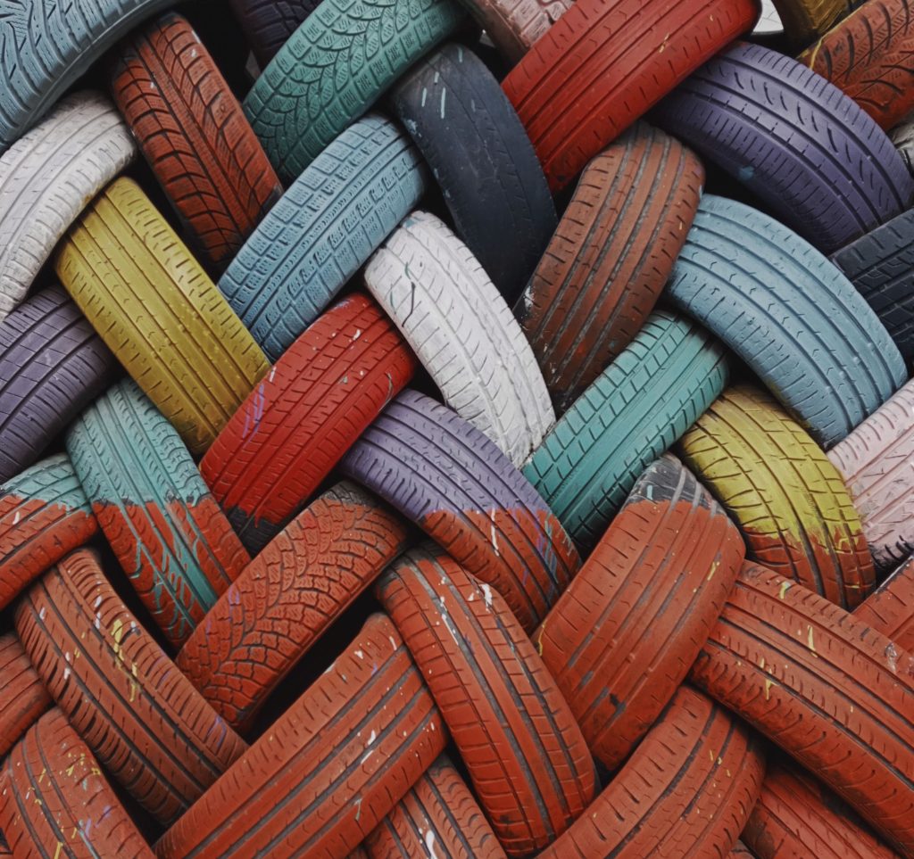 Colorful intertwined tires creating a unique geometric pattern, perfect for modern art decoration.